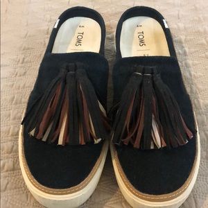 Tom’s black slip ons
